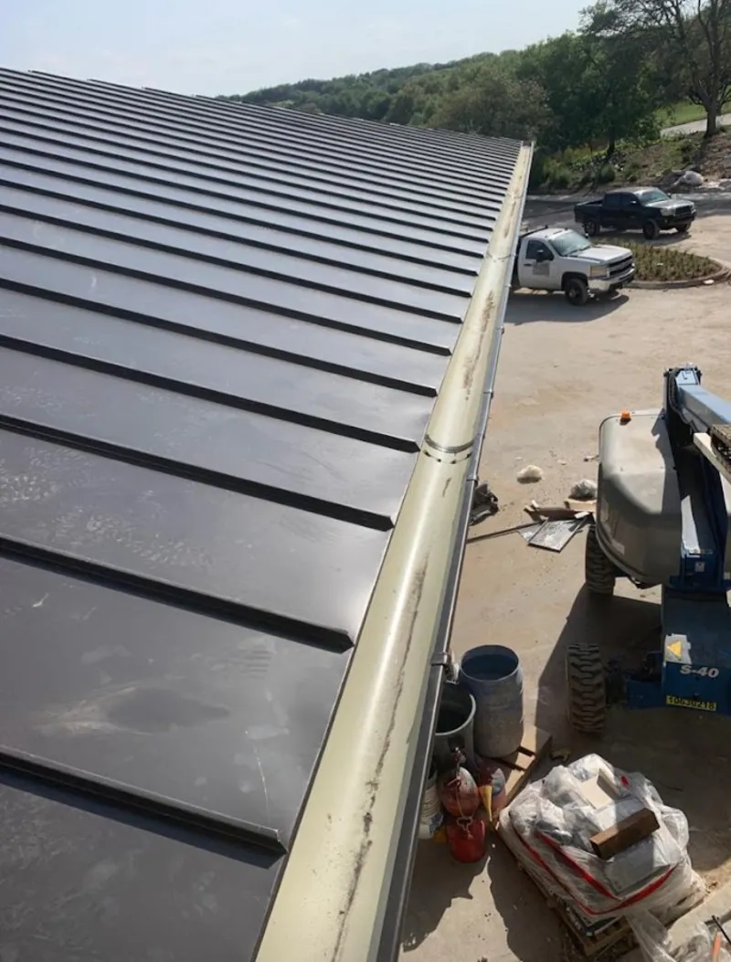 Standing seam panel and gutter detail on a metal roofing jobsite in Jamestown